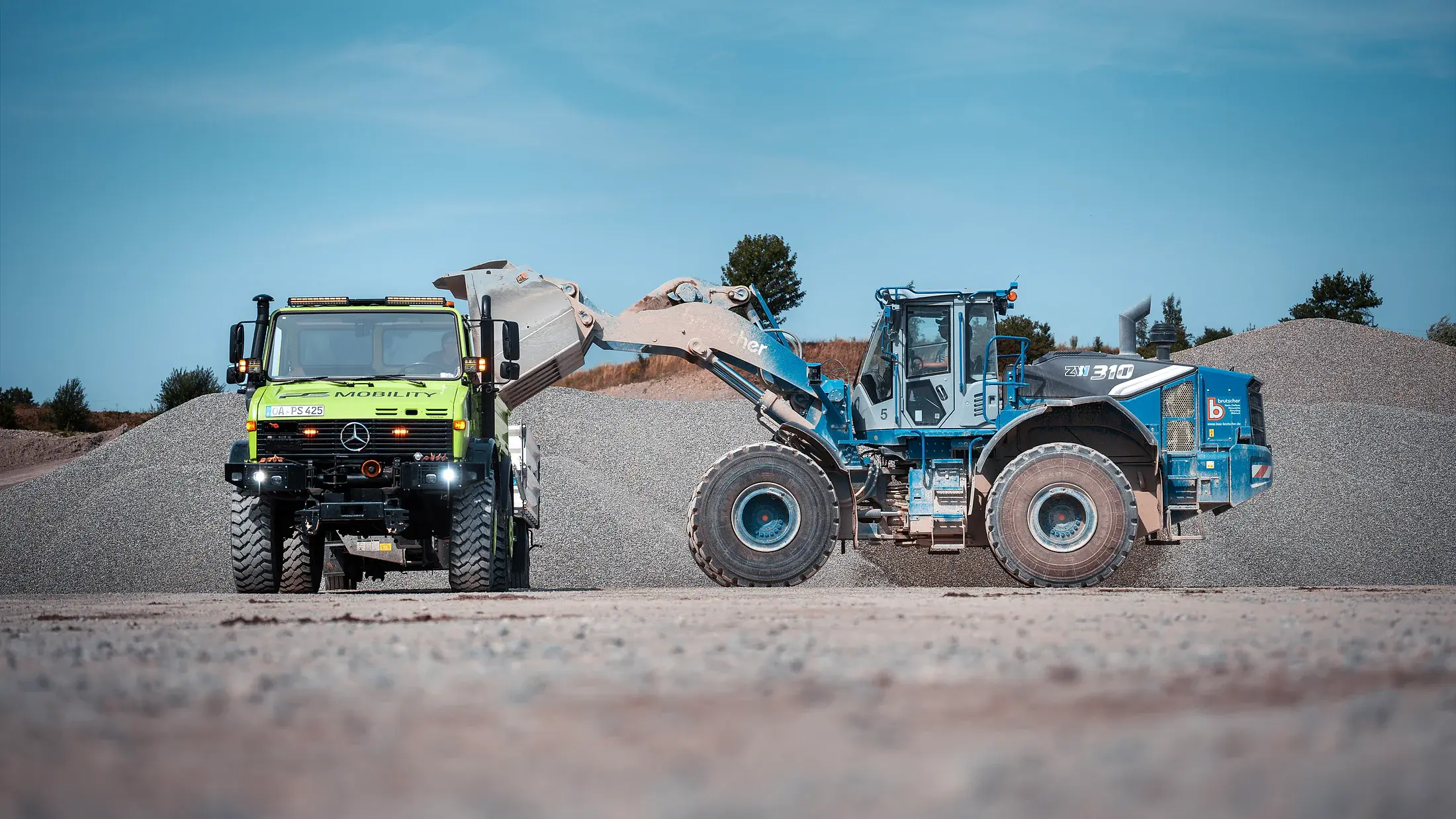 Fuhrpark von PS-Mobility im Raum Kempten. Radlader belädt den Unimog